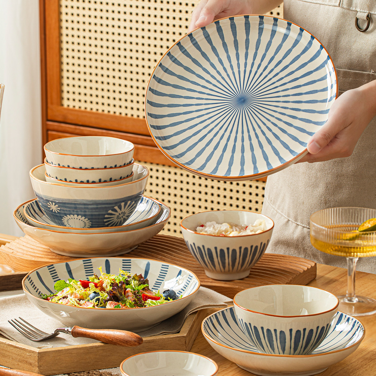 Blue Rhyme plate held above a set table, styling inspiration