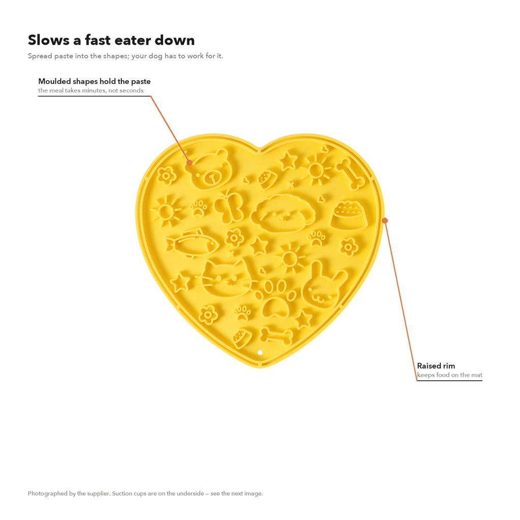 Arrows marking the molded grooves and the raised rim on the heart-shaped lick mat