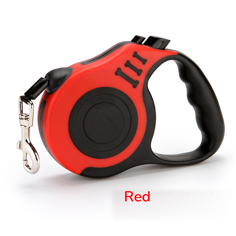 Red retractable leash with a black grip, side view on white