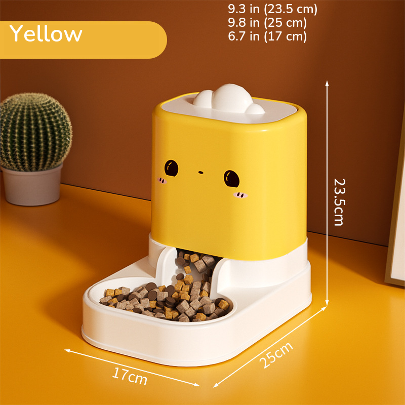 Yellow cartoon-face food feeder with kibble, marked 9.3 in (23.5 cm) tall on a 9.8 x 6.7 in (25 x 17 cm) base