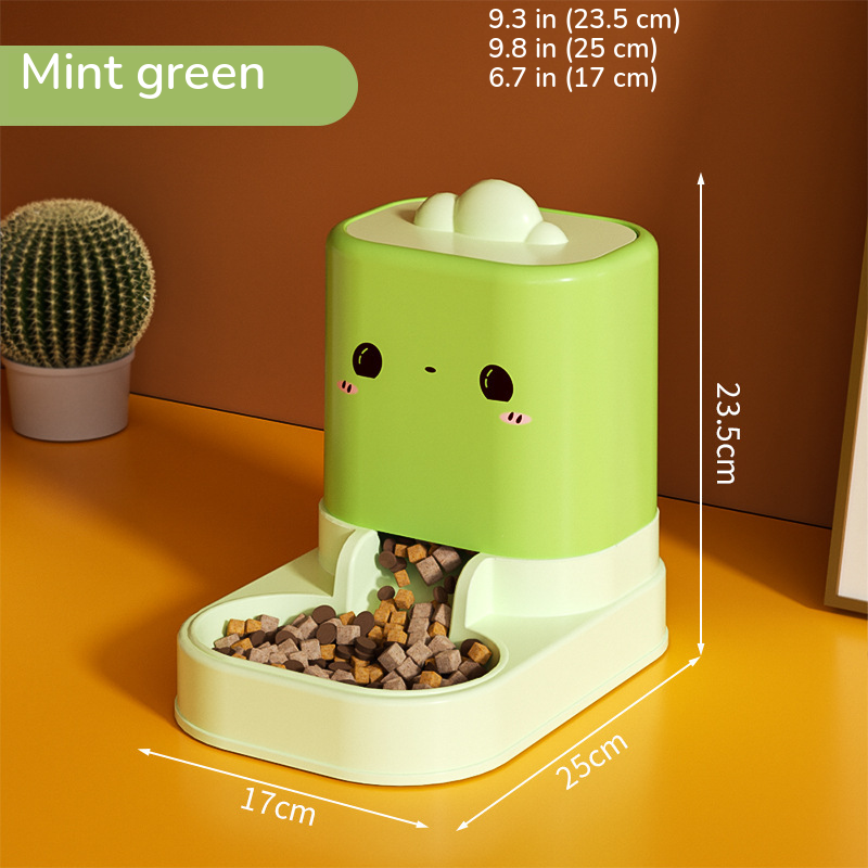 Green cartoon-face food feeder with kibble in the dish, marked 9.3 in (23.5 cm) tall