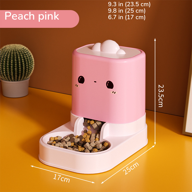 Pink cartoon-face food feeder with kibble in the dish, marked 9.3 in (23.5 cm) tall