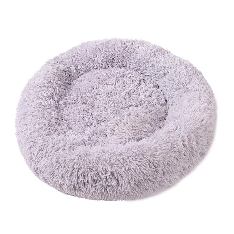 Pale gray plush donut bed shown empty on a white background, angled to show the raised rim