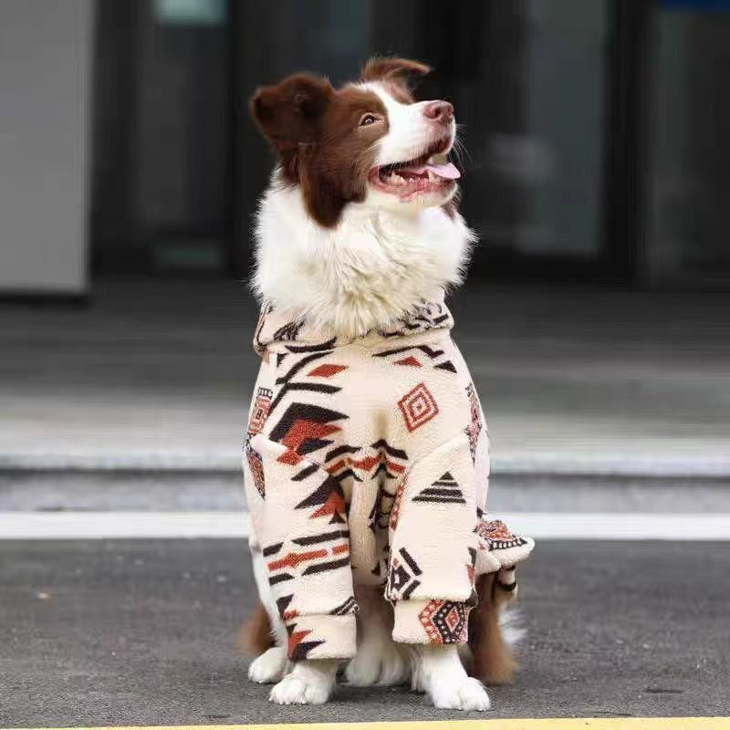 The cream patterned fleece seen head-on as the dog sits looking up, both front legs in sleeves