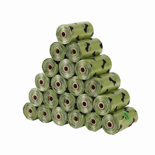 Stack of green dog poop bag rolls with a bone print