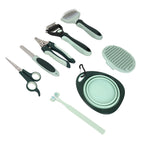 The eight tools from the sage green grooming kit laid out on white