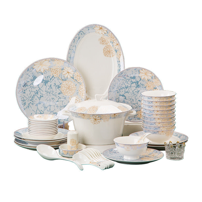 The full bone porcelain set laid out on a white background: dinner plates, side plates, footed rice bowls, a lidded tureen, sauce dishes, spoons and serving pieces