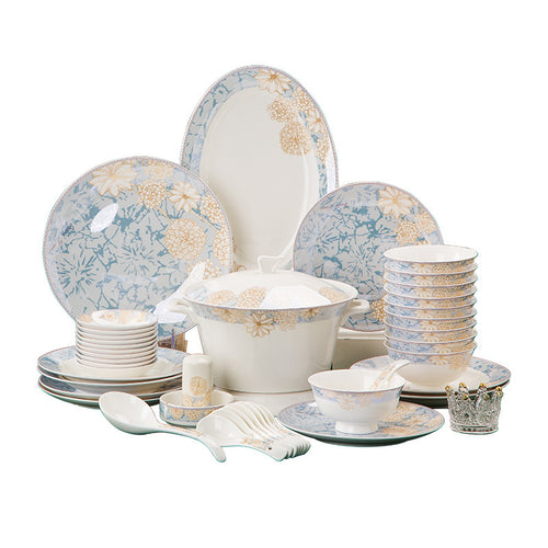The full bone porcelain set laid out on a white background: dinner plates, side plates, footed rice bowls, a lidded tureen, sauce dishes, spoons and serving pieces