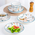 The set on a white table: a bowl on a plate on a woven mat, a small bowl of quail eggs, a deep plate of salad with a gold fork and a pepper grinder behind.