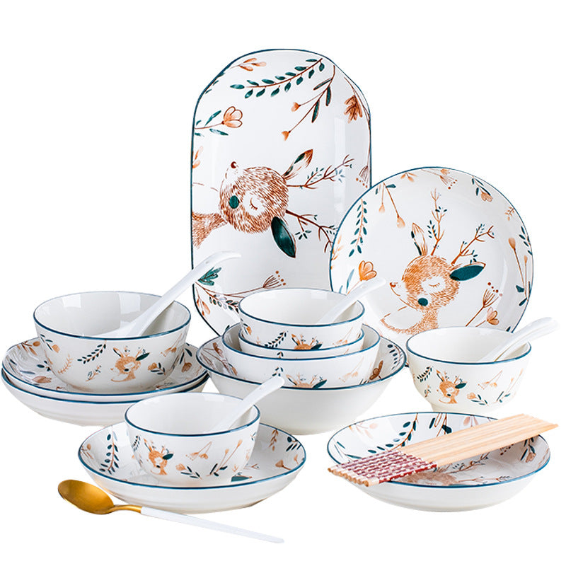 The set arranged on a white background: an oval platter and plates printed with a fawn and a rabbit among leaves, stacked bowls, spoons and chopsticks.