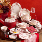Red Botanical Table Set in a Gift Box. A cream body with a red botanical print that runs across the plates, inside the bowls and over the lid of the covered pot.