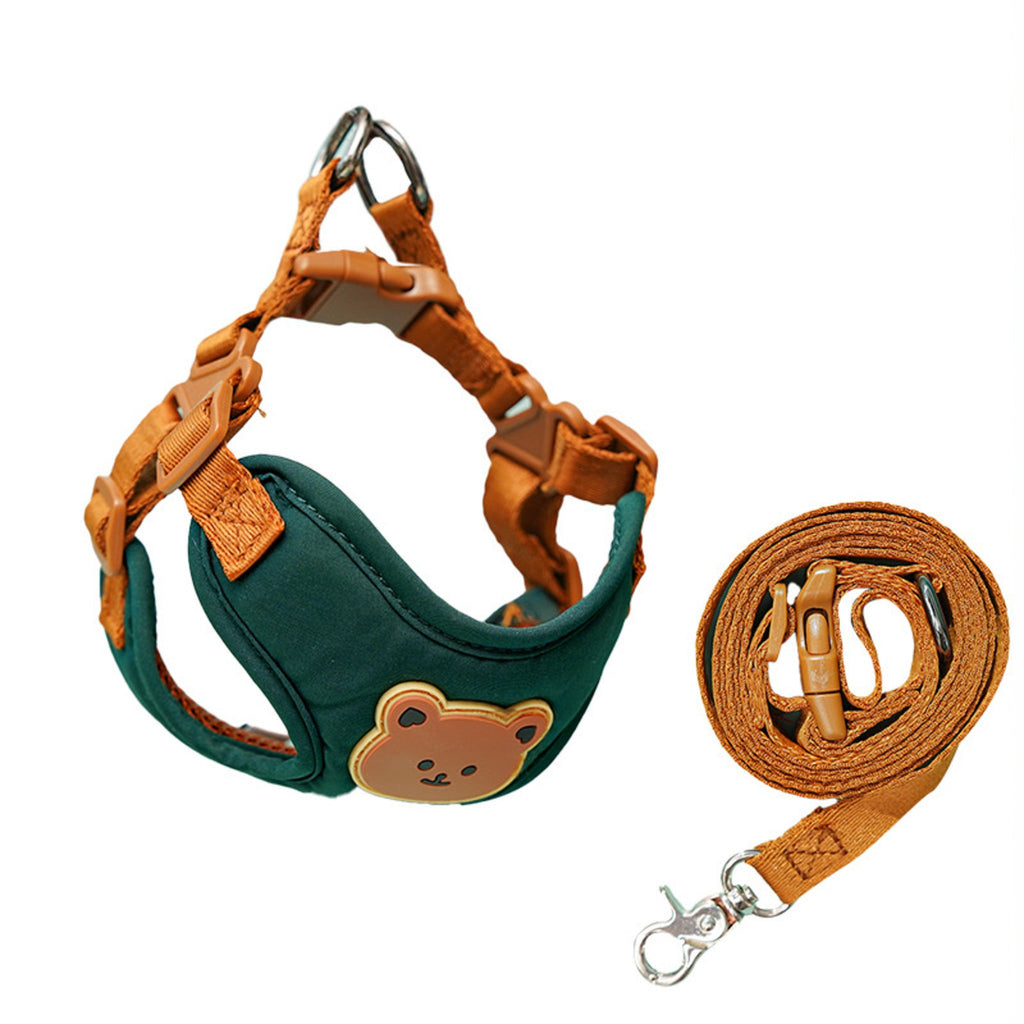 Dark green vest harness with tan straps and bear patch beside its coiled lead