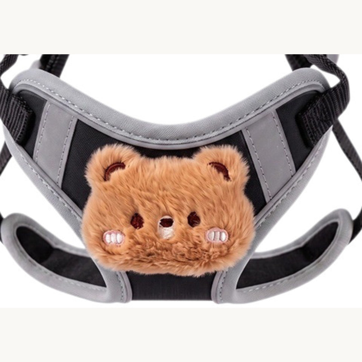 Close-up of the plush bear head stitched onto the black padded chest panel