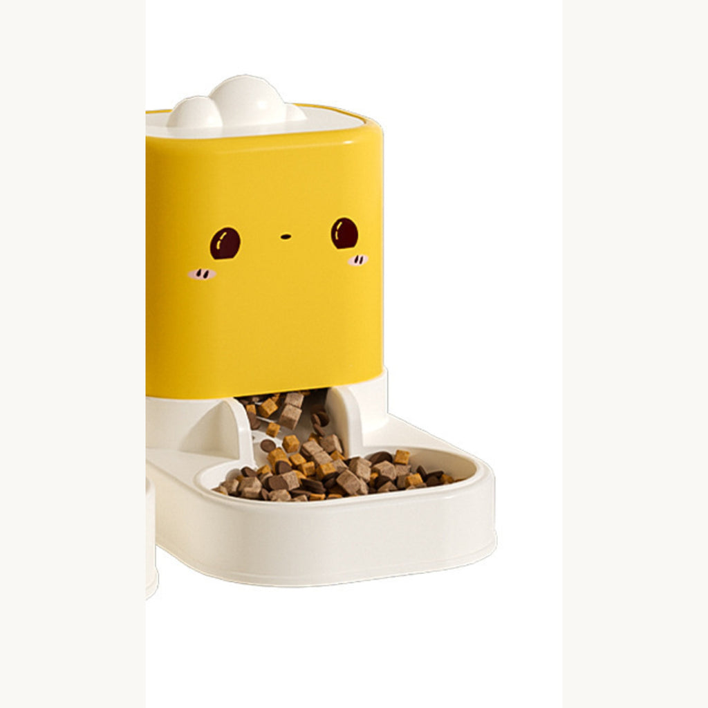 Yellow feeder with a printed face, kibble resting in its white tray