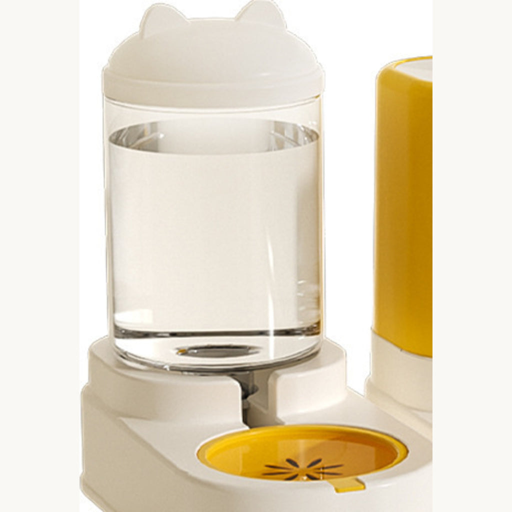 Clear water bottle on the white base with the yellow drinking dish underneath