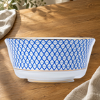 Dongli 6 in noodle bowl in blue lattice bone porcelain on a wooden table.