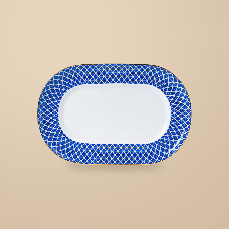 Dongli 12 in oval platter in blue lattice bone porcelain with a gold rim.