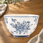 Blue and White Rainy Day 4.5 in rice bowl on a wooden table in soft daylight.
