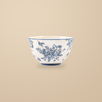 Blue and White Rainy Day 4.5 in rice bowl with a blue floral print, on a warm beige background.
