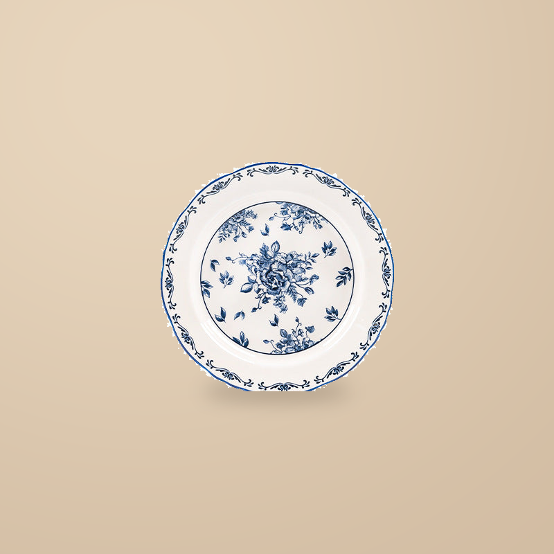 Blue and White Rainy Day 8 in plate with a blue floral print, on a warm beige background.