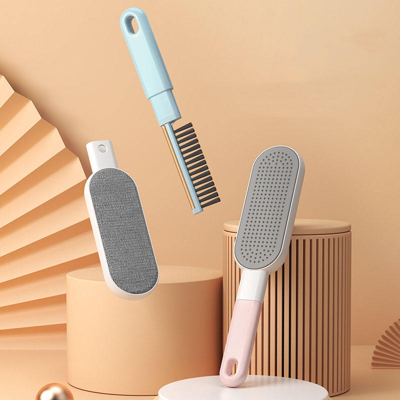 Blue and pink double-sided pet hair remover brushes with a detachable comb on a beige backdrop