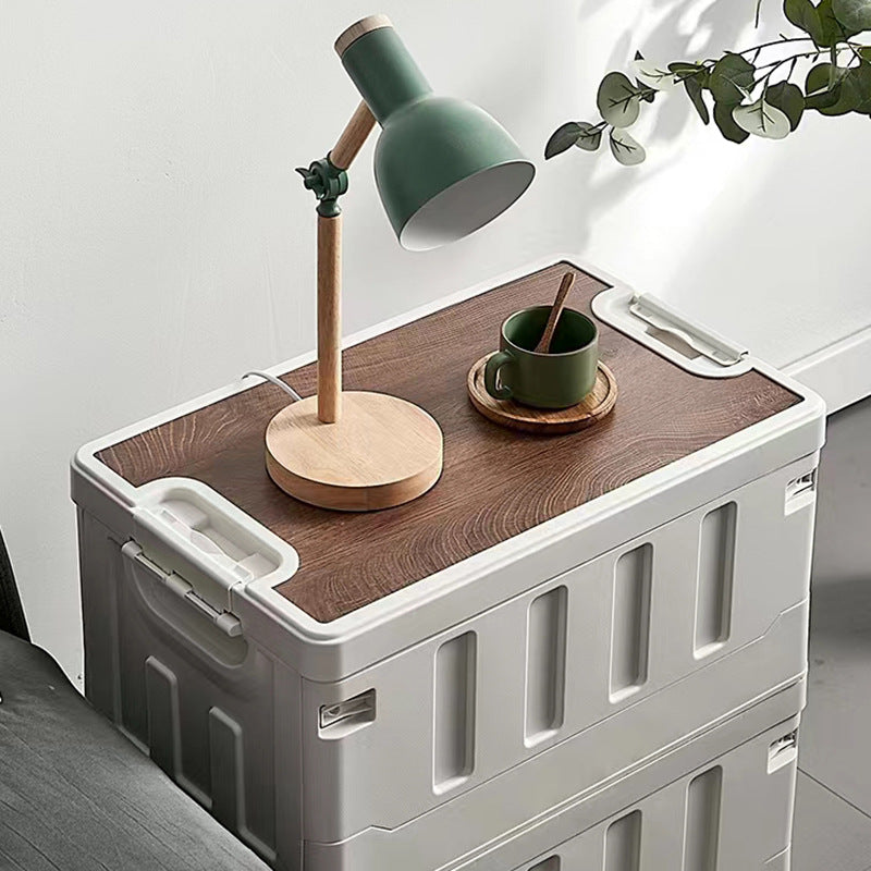 White foldable storage organizer stacked indoors with a lamp and cup on top
