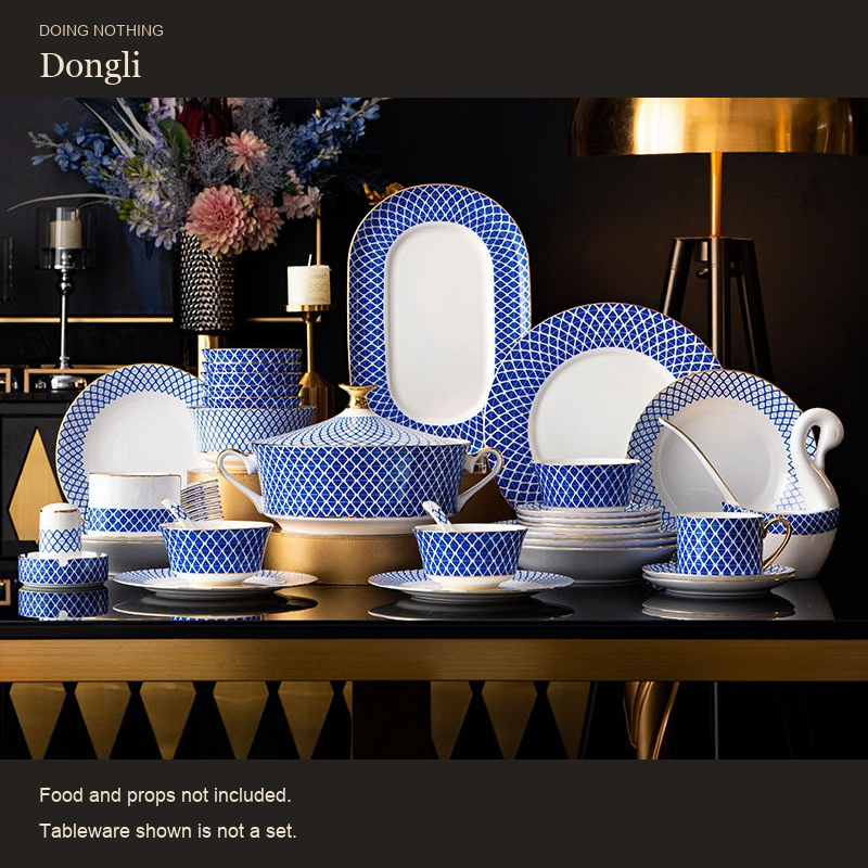 Dongli blue lattice bone porcelain set out on a dark table, styling. Food and props not included.
