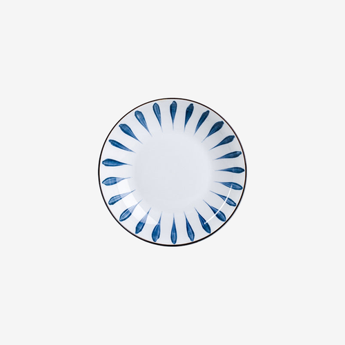 A shallow plate with a ring of blue brushed petals around a white centre, seen from above.
