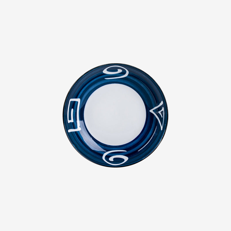 A shallow plate with a deep blue brushed rim and white looping marks, seen from above.