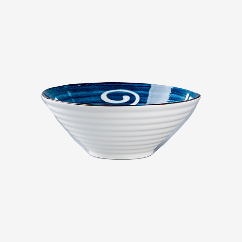 A ribbed white flared bowl with a deep blue brushed rim and a white looping mark, seen from the side.