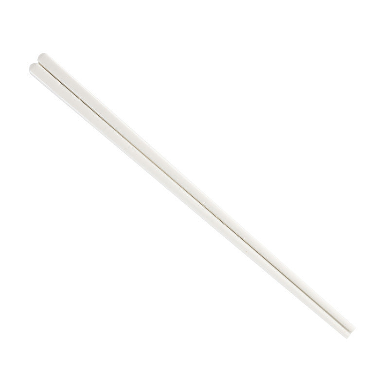 A pair of plain white chopsticks on a white background.