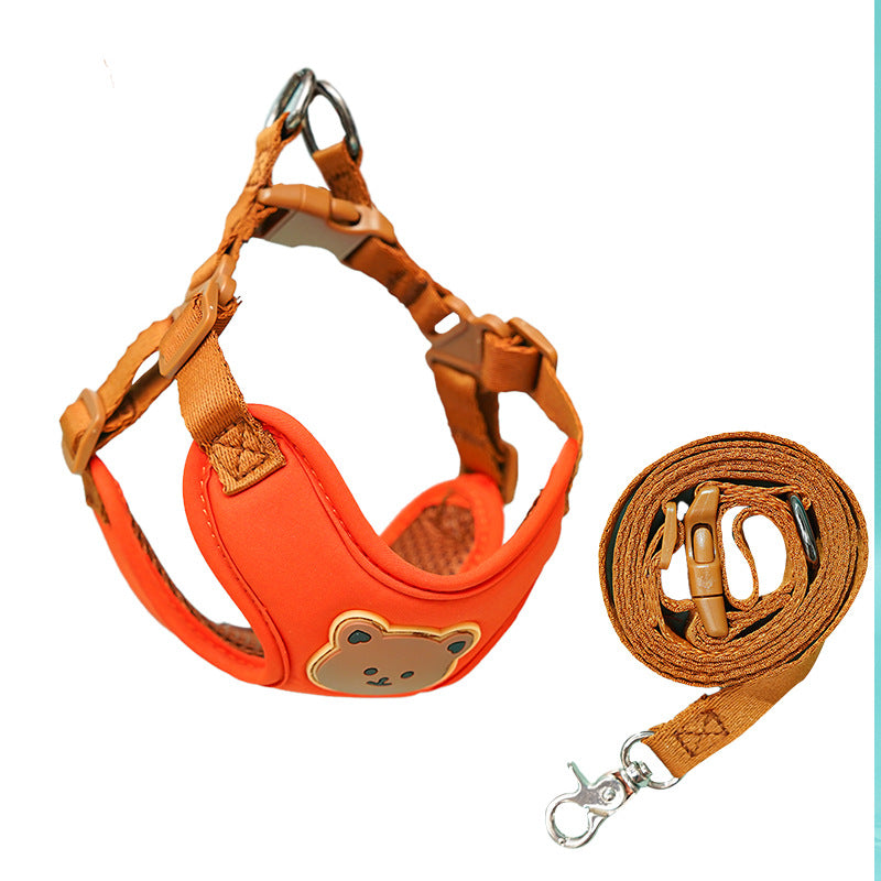 Orange bear-face harness with tan straps, shown with its coiled leash on white