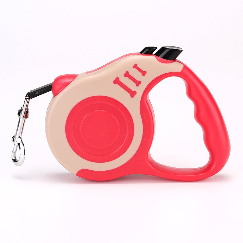 Coral red and cream retractable leash with a coral grip, side view on white