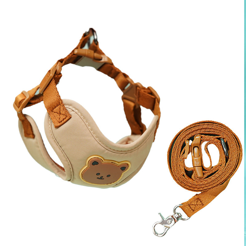 Cream bear-face harness beside its coiled tan leash and clip on white