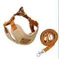 Cream bear-face harness beside its coiled tan leash and clip on white