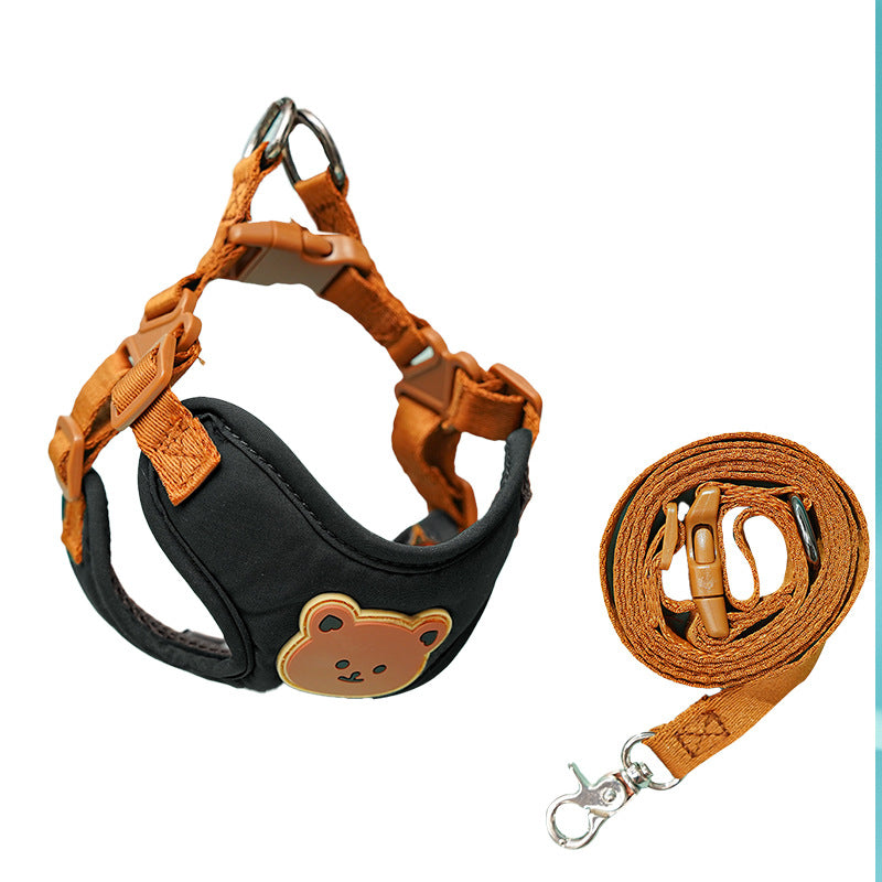 Black bear-face harness with tan straps, shown with its coiled leash on white