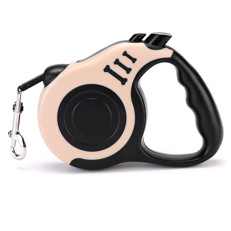 Beige and black retractable leash with a black grip, side view on white