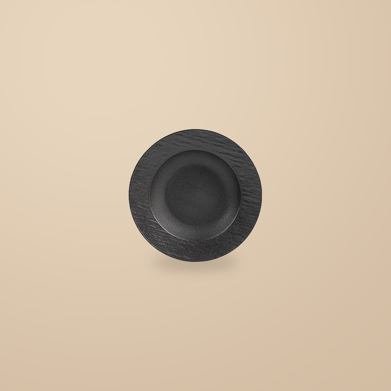 Rock Texture black 9 in pasta bowl, on a warm beige background.