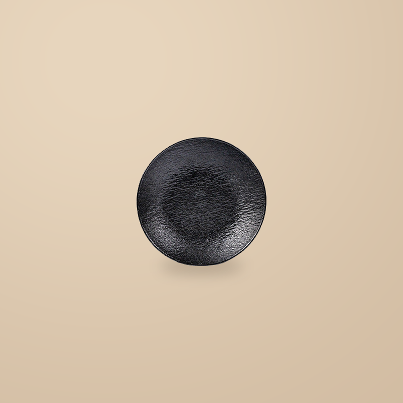 Rock Texture black 8 in deep plate, on a warm beige background.