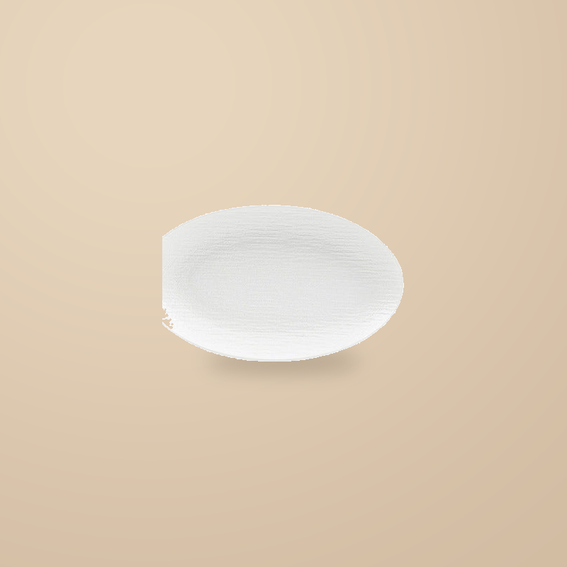 Rock Texture white 12 in oval platter, on a warm beige background.