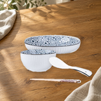 Yamada Sakura pattern pieces on a wooden table: rice bowl, plate, spoon and chopsticks.