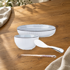 Yamada Spring pattern pieces on a wooden table: rice bowl, plate, spoon and chopsticks.
