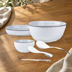 Yamada Spring pattern pieces on a wooden table: rice bowl, plate, soup bowl, spoons and chopsticks.