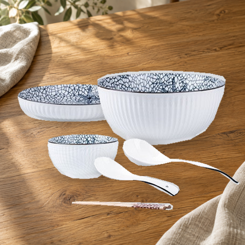 Yamada Starfish pattern pieces on a wooden table: rice bowl, plate, soup bowl, spoons and chopsticks.