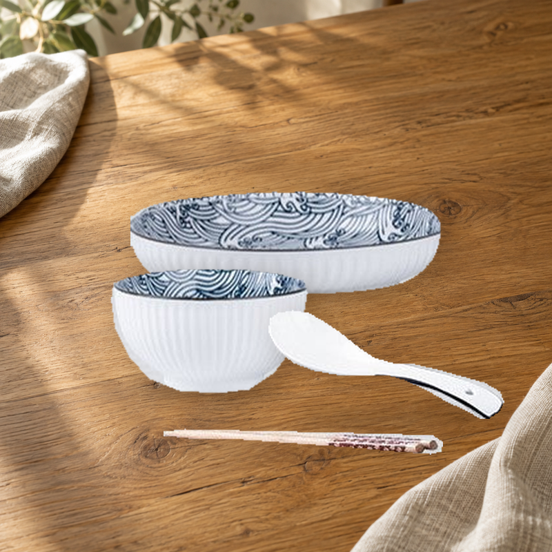 Yamada Wave pattern pieces on a wooden table: rice bowl, plate, spoon and chopsticks.