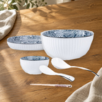 Yamada Wave pattern pieces on a wooden table: rice bowl, plate, soup bowl, spoons and chopsticks.