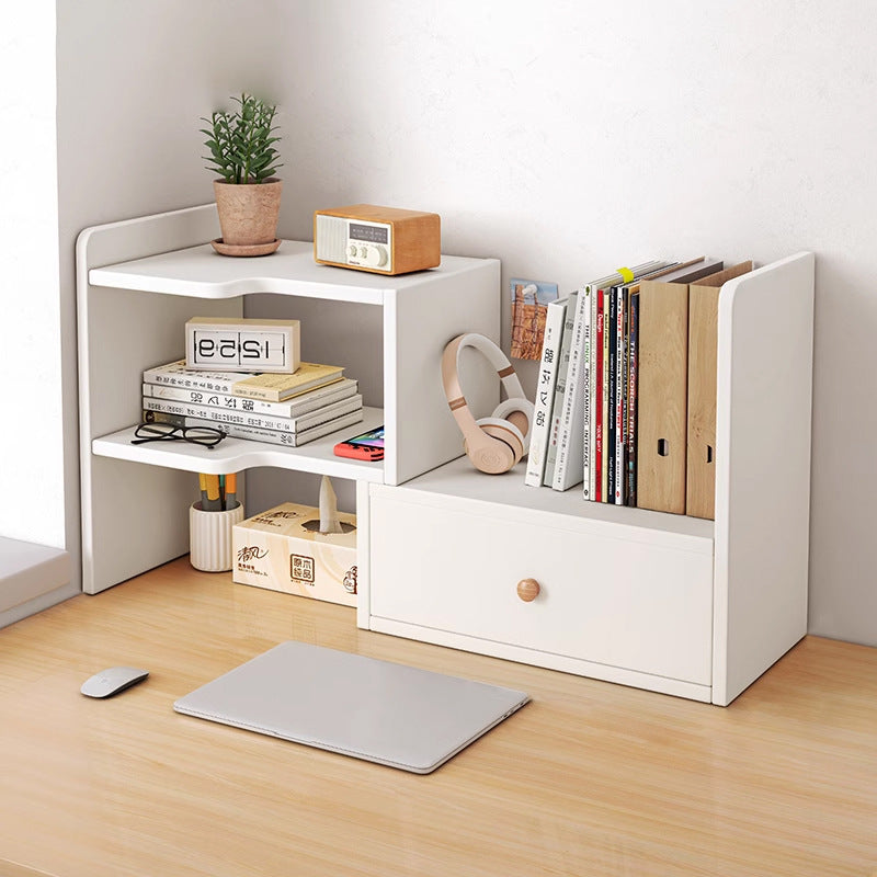 White adjustable desktop bookshelf with drawer holding books, a clock and a plant