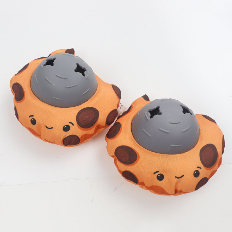 Two cookie-style plush dog toys in orange with grey balls and stitched smiling faces