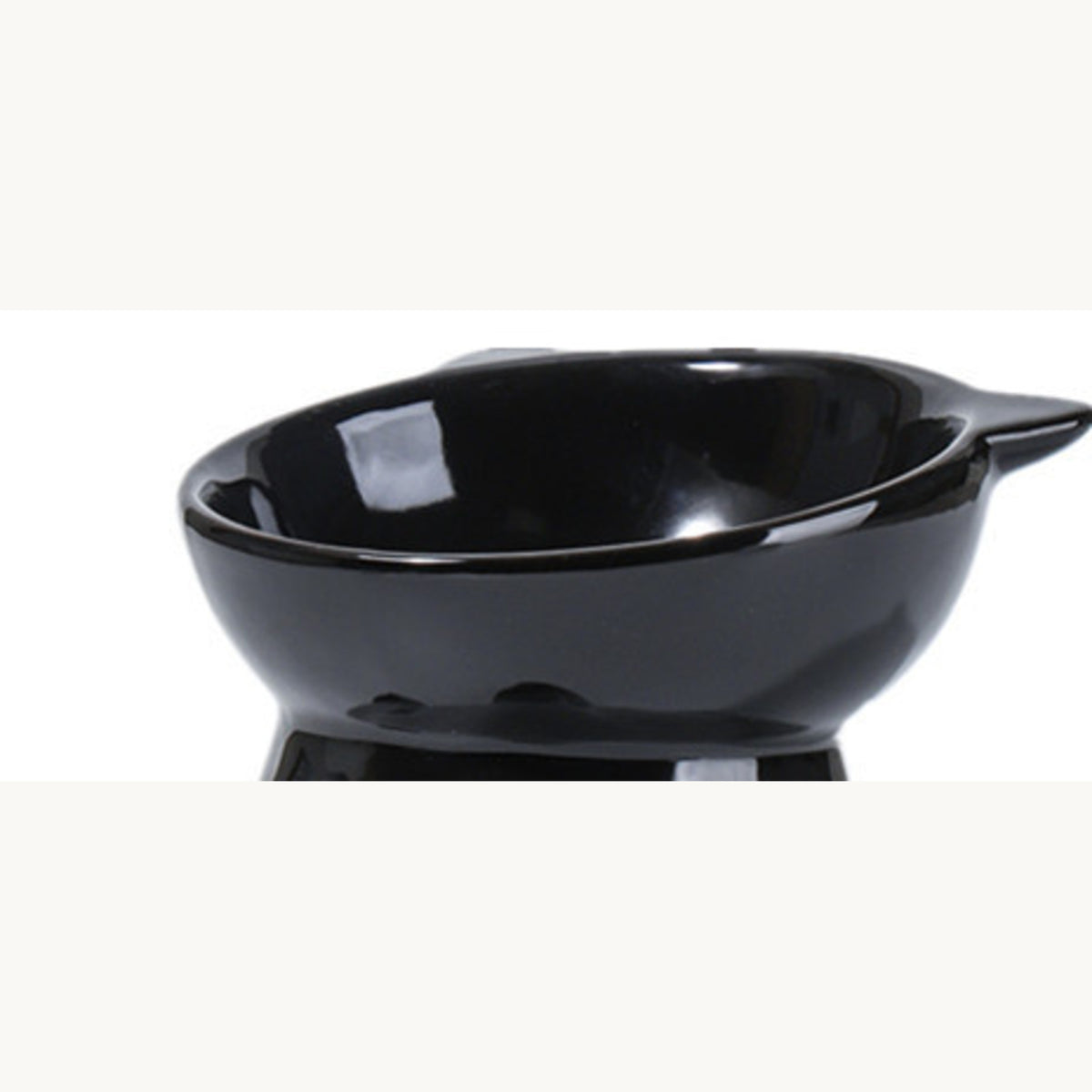 Black tilted pet bowl on its pedestal, three-quarter view
