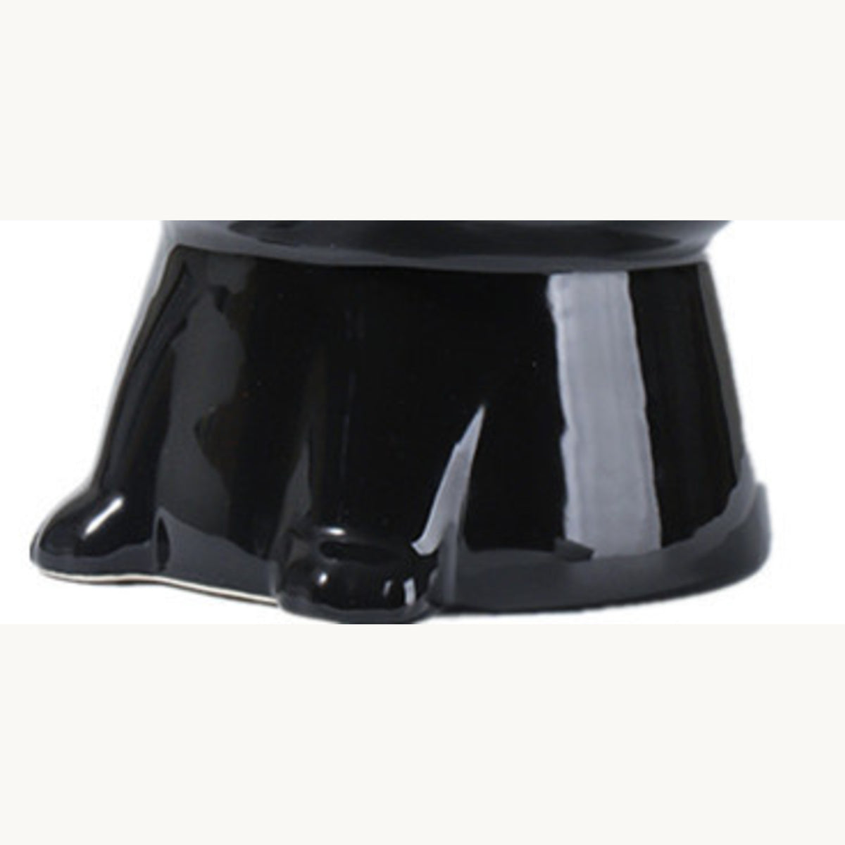 Black tilted pet bowl from the side, showing the angle of the pedestal base